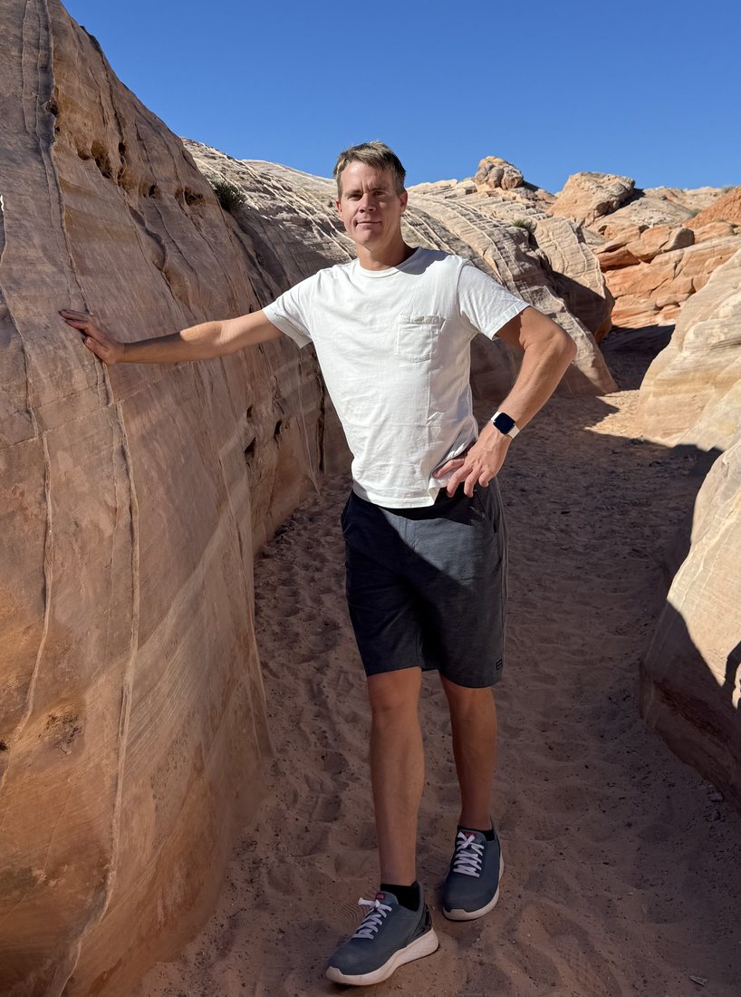 Jason standing outdoors among red sandstone rock formations a few years after his injury